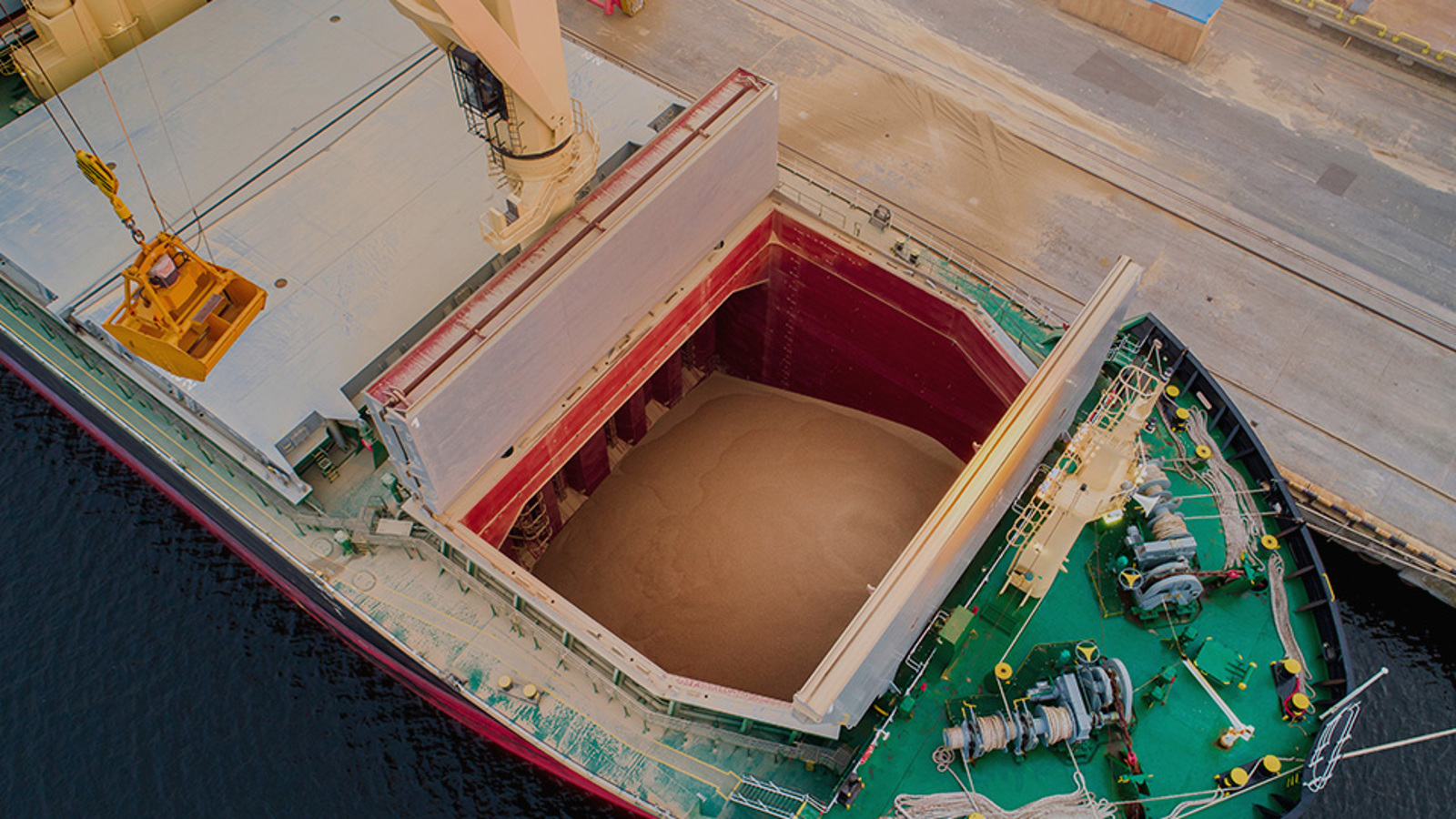 View into the hatch of a dry bulk carrier ship with grain inside