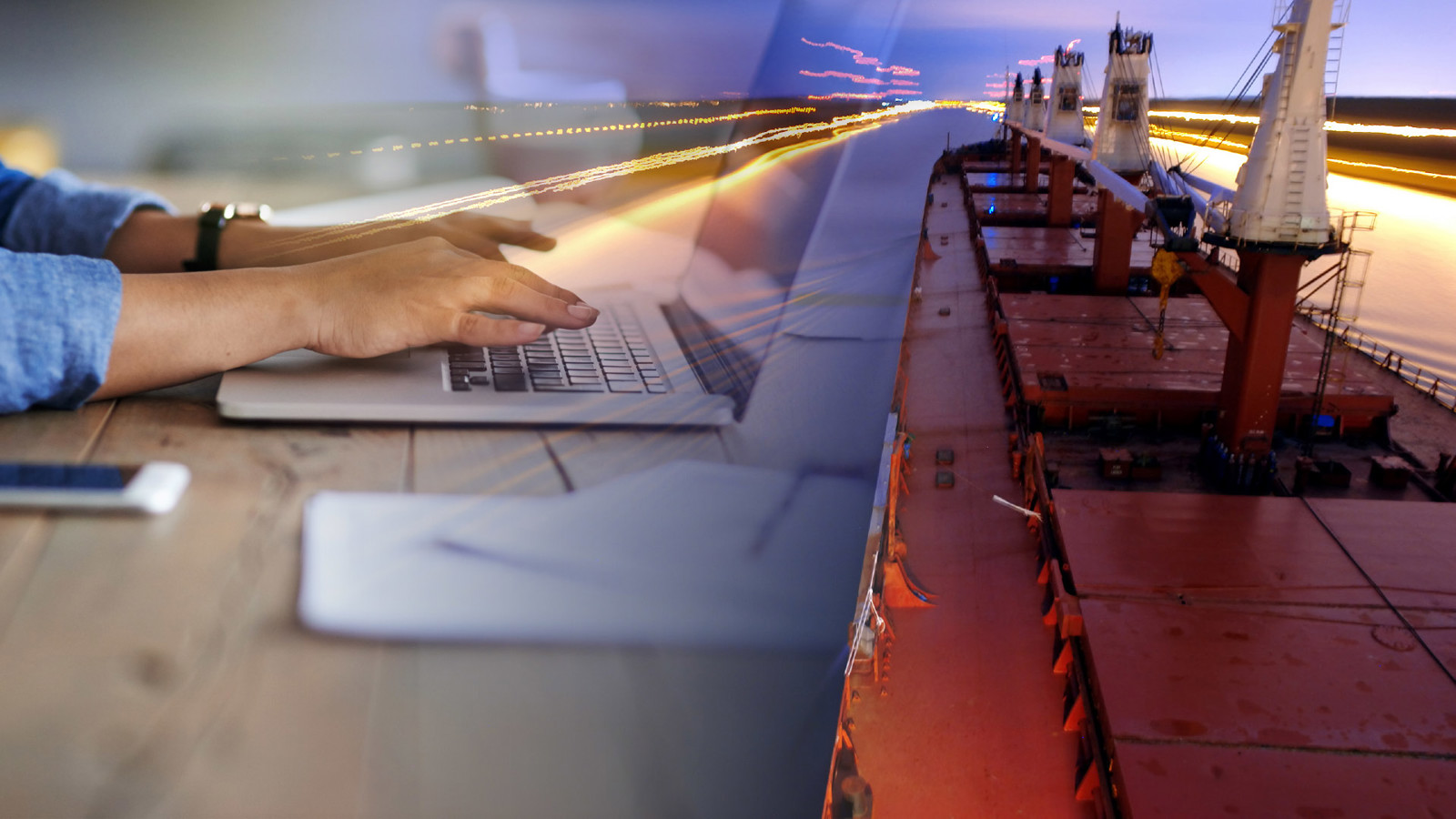 collage of hands working on a laptop on the left, red bulker ship navigating a canal on the right