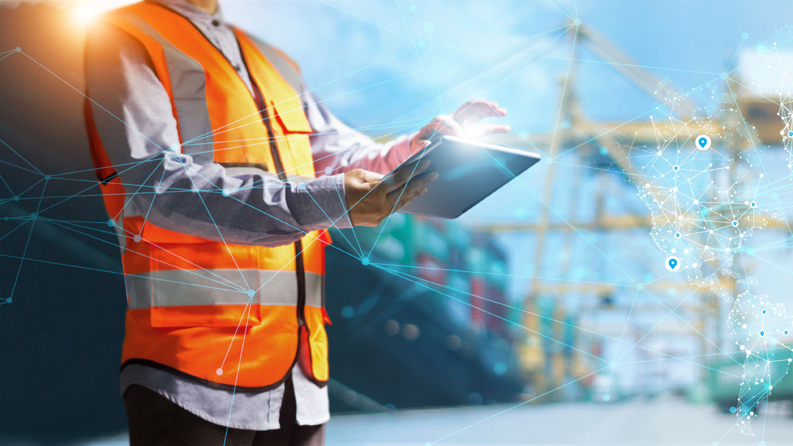 person in orange safey vest typing on a computer