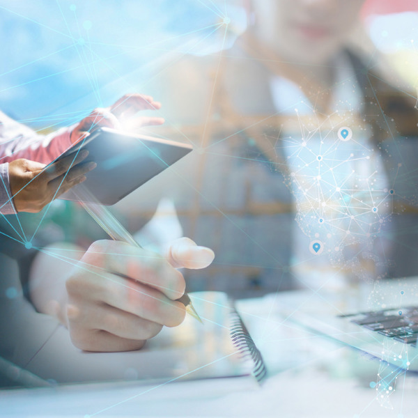 person in orange safey vest typing on a computer